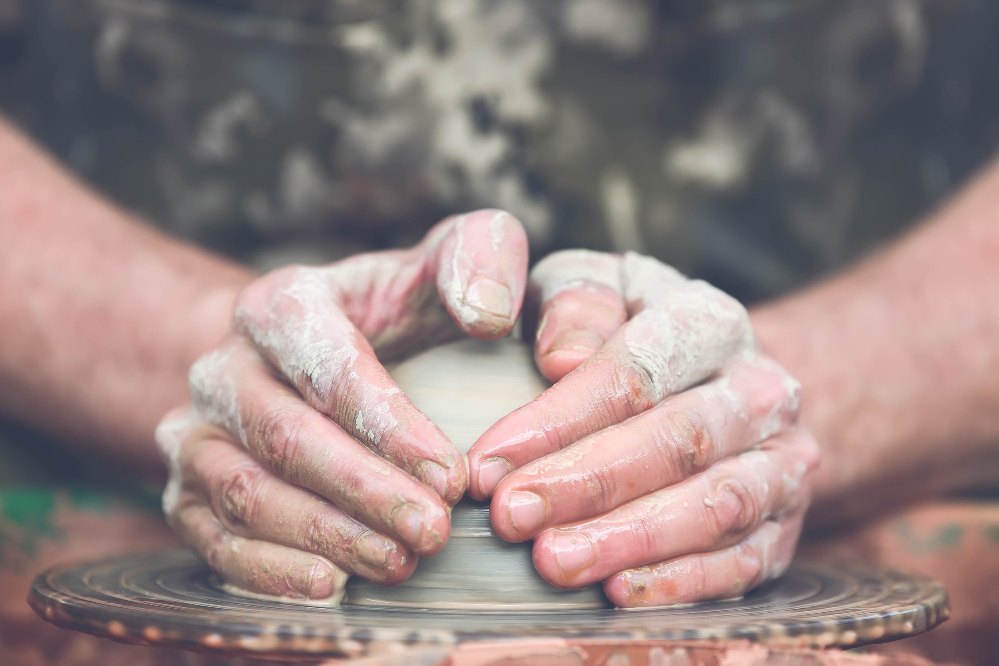 Potter making ceramic pot on the pottery wheel