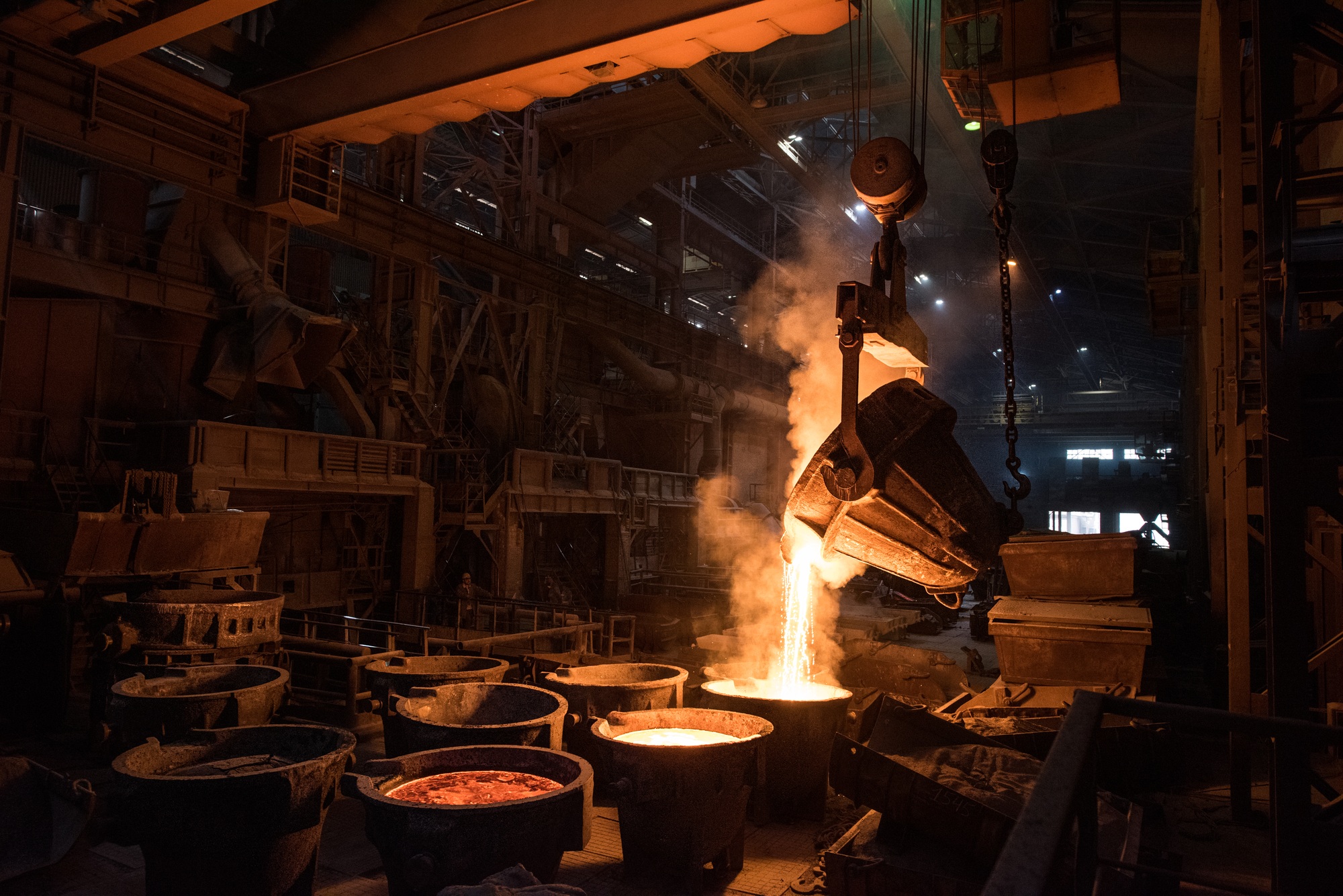 Tank pours liquid metal in the molds at the steel mill. Interior of a steel mill.