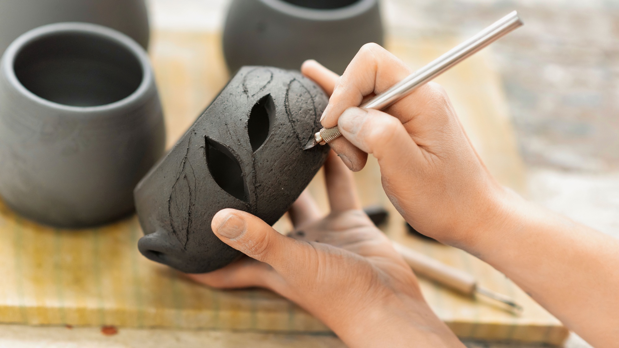 The master of sculpting pottery working in a studio
